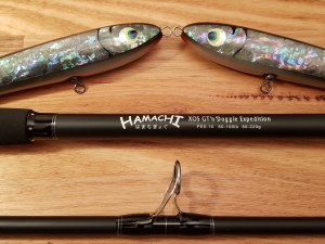 Hamachi XOS GT'n'Doggie Expedition PE6-10 rod label next to abalone shell stickbait lures