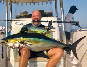 Angler holding a yellowfin tuna caught on a Hamachi rod