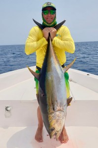 Angler holding the same tuna landed, on a Hamachi rod