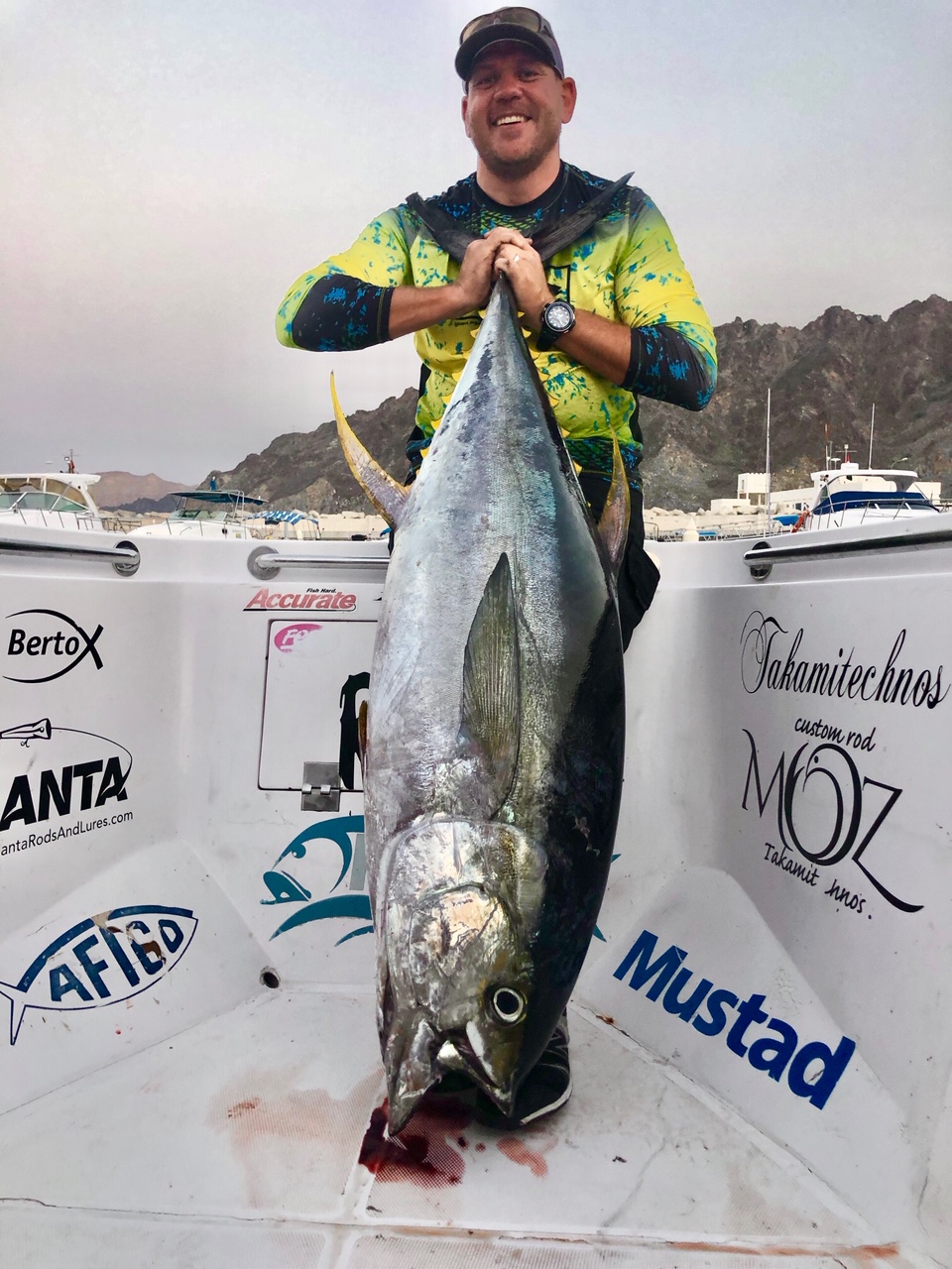 Angler holding a large yellowfin tuna caught on a Hamachi rod, Gulf of Oman