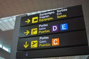 Airport baggage and gate signage in a foreign terminal
