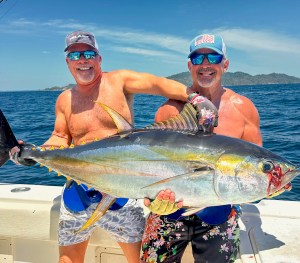 Two anglers holding a large yellowfin tuna caught in Panama